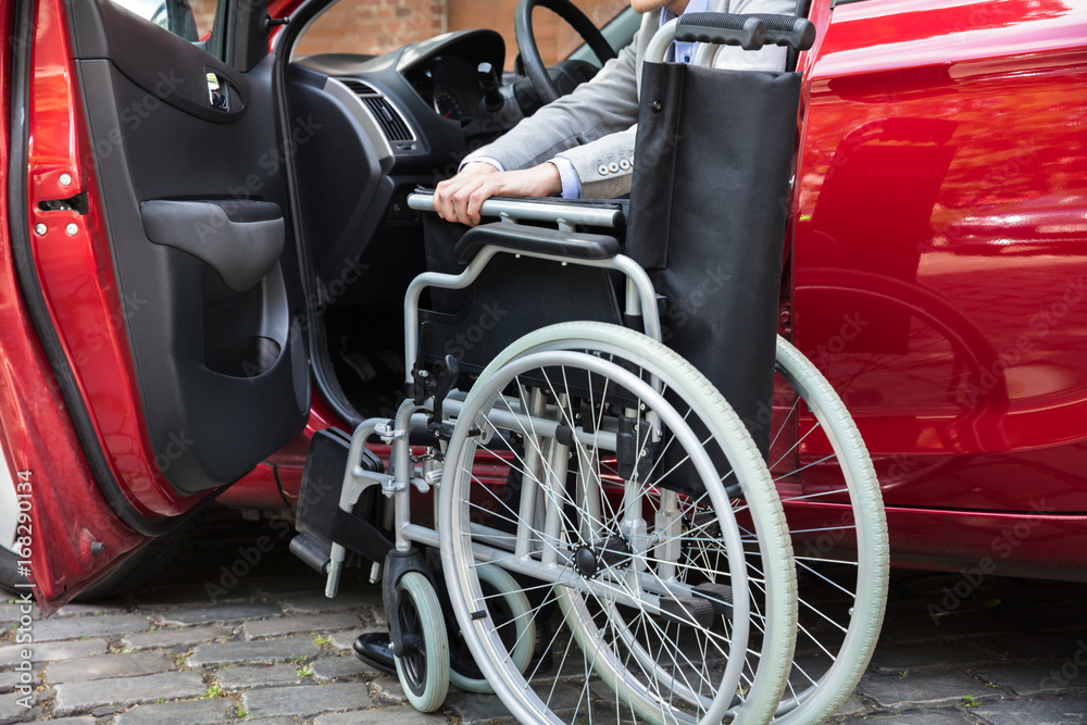 Man Sitting In Car Folding His Wheelchair Man Sitting In Car Folding His Wheelchair