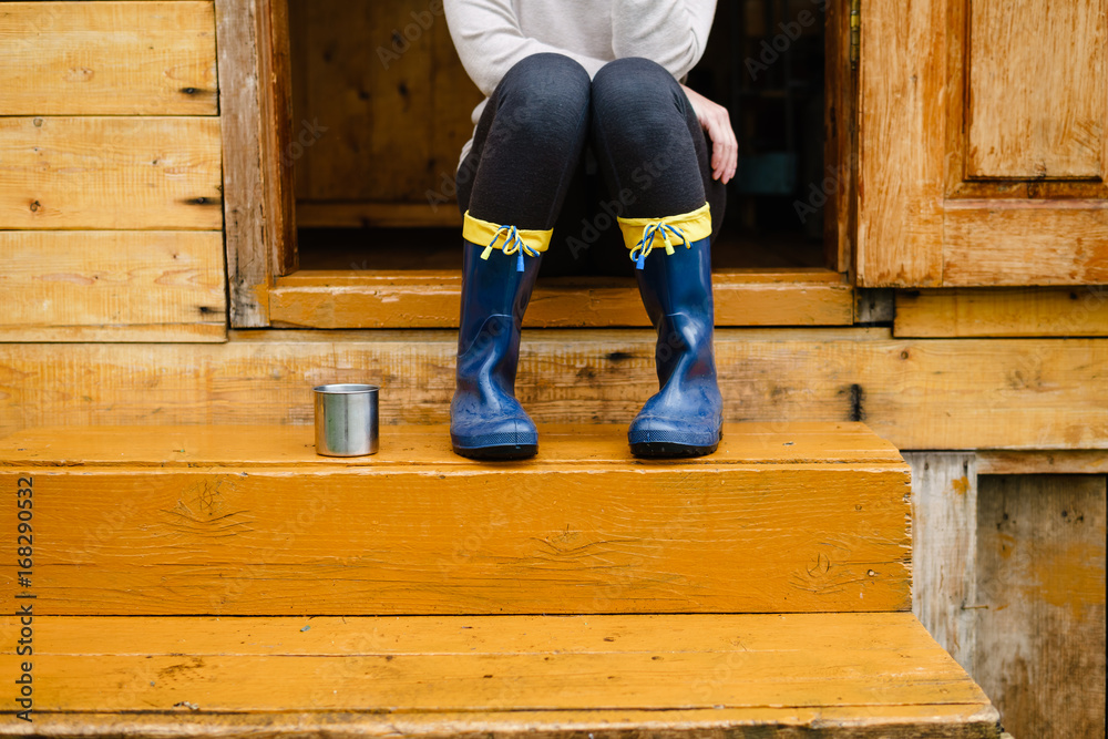 A woman sitting on wooden steps. A woman sitting on wooden steps.