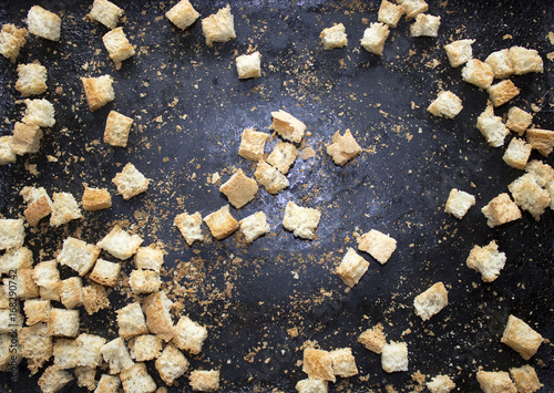Dark background iron baking sheet crackers bread crumbs