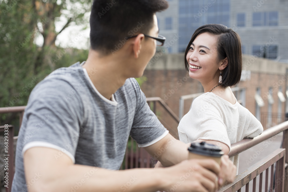 Cheerful young couple talking outdoors Cheerful young couple talking outdoors