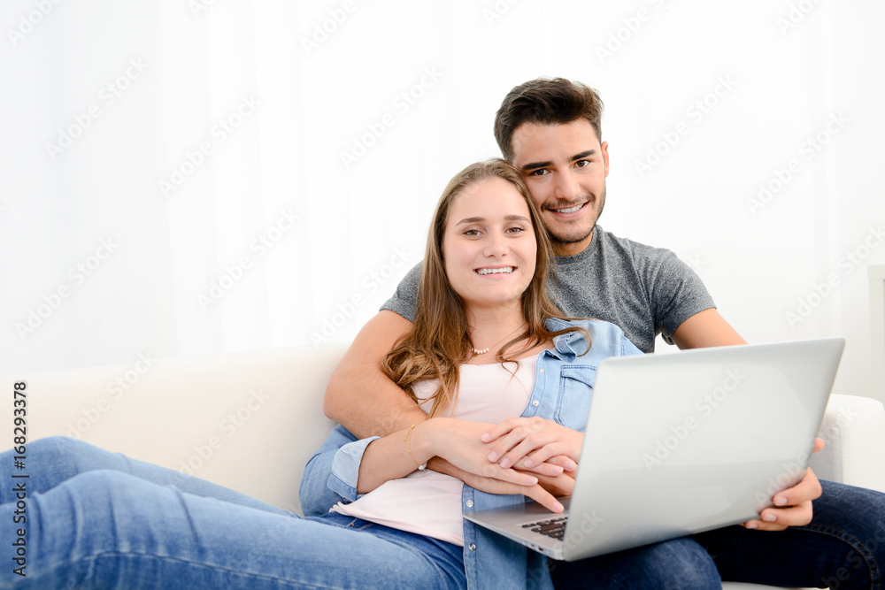 portrait of young and happy couple at home making project for future with laptop computer on internet portrait of young and happy couple at home making project for future with laptop computer on internet