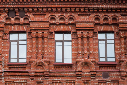 Three high windows in the red house photo