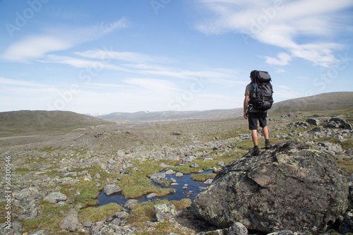 Hiker stands on a rock, Haltitunturi, summer