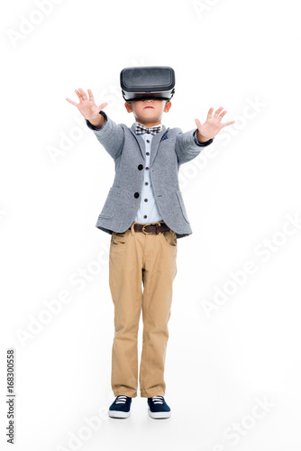 schoolboy in VR headset with outstretched hands