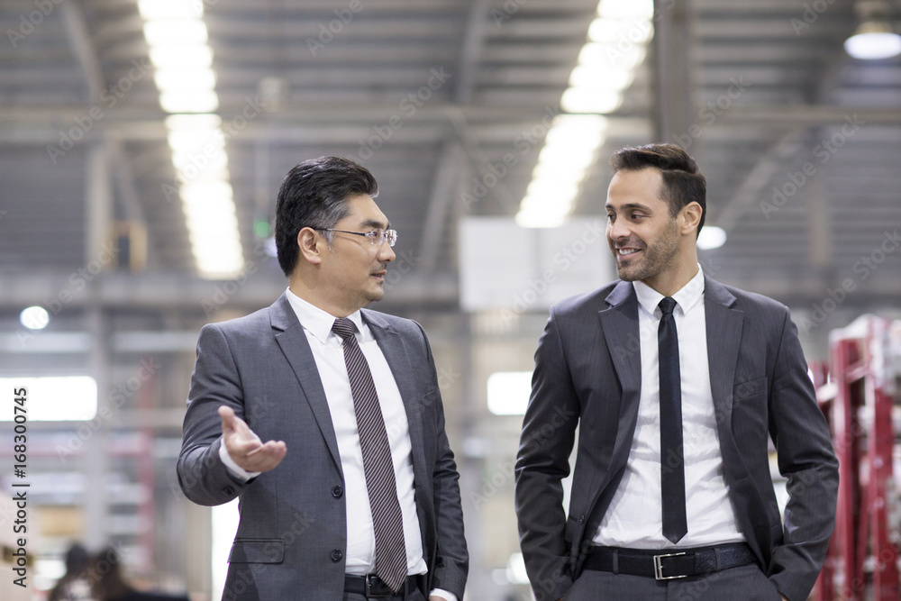 Business people talking in the factory Business people talking in the factory
