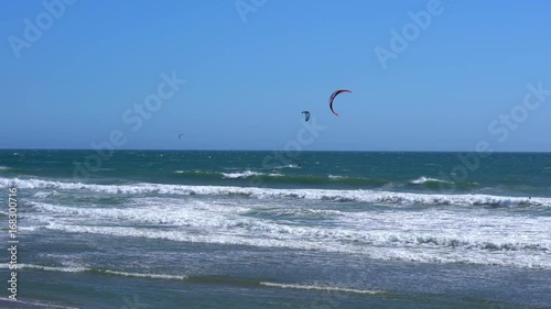 Remote view at kite surfers riding the waves in Santa Cruz, California
