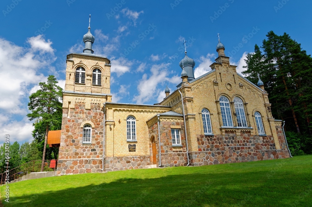 Old orthodox church with domes, built of bricks.