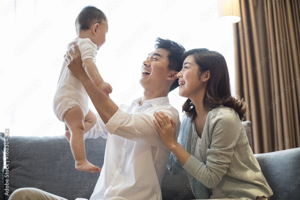 Father and mother playing with child at home Father and mother playing with child at home