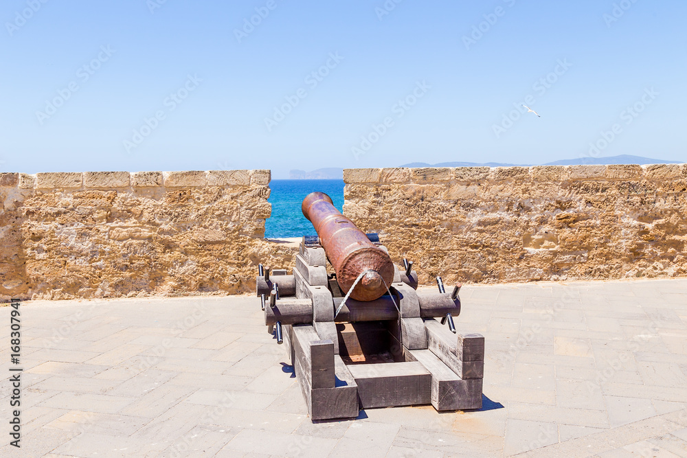 Alghero, Sardinia, Italy. An ancient cannon on the coastal bastion Alghero, Sardinia, Italy. An ancient cannon on the coastal bastion