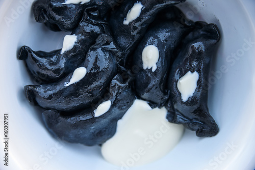 Black Russian dumplings vareniki in bowl photo