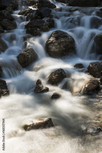 Stream with Rocks and Sun