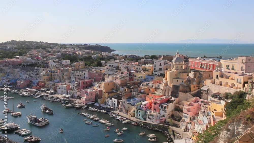 Procida, Corricella marina at sunset. Panoramic view of the old village of fishermen's houses and the marina of Corricella, a classic panoramic view of the island of Procida, Italy.