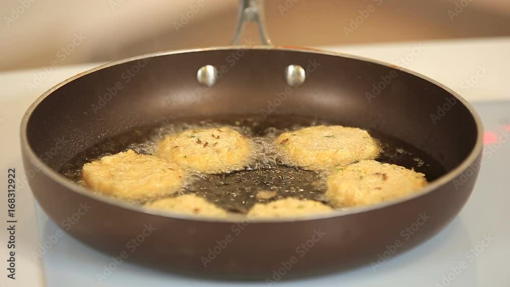 Chef is frying veggie burgers on a pan Chef is frying veggie burgers on a pan
