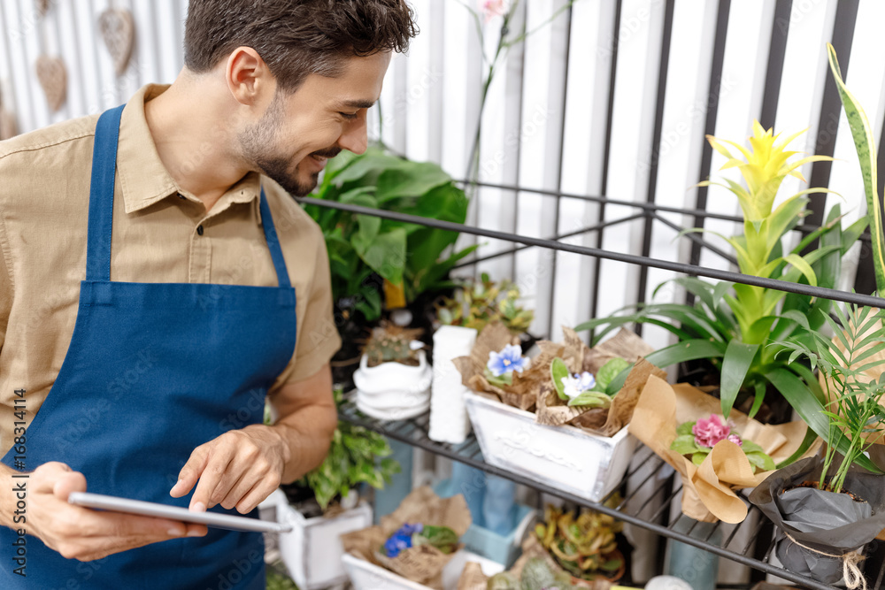 male florist with digital tablet male florist with digital tablet