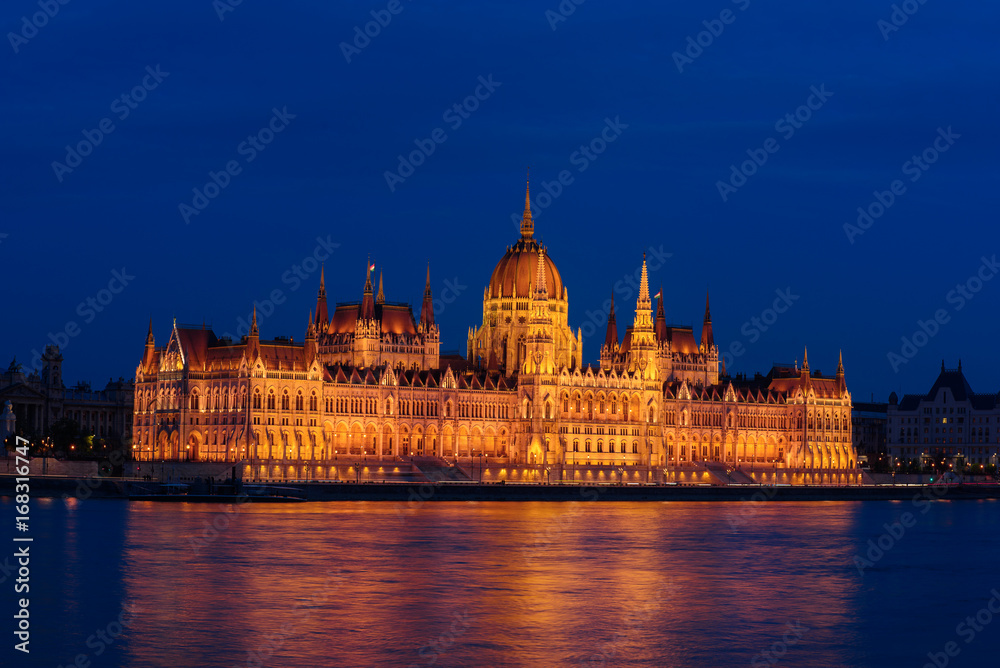 Budapest Parliament building and Danube river at night with illumination, travel sightseeing background