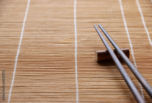 Wooden chopsticks on Bamboo table,Japanese and Chinese food equipment,with copy space