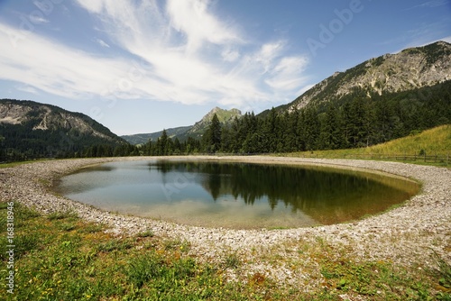 Fototapeta Naklejka Na Ścianę i Meble -  Alpine landscape with storage pond 