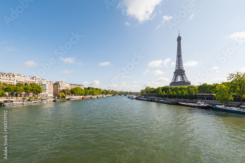 Paris and Eiffel tower with river Seine in the foreground on a sunny day, France