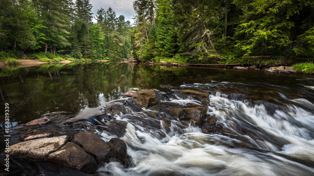 Monument Falls along the Ausable River in Lake Placid, new York on a summer morning. Monument Falls along the Ausable River in Lake Placid, new York on a summer morning.