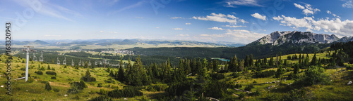 View on a distant mountain and a lake in the forest. Black lake at mountain Durmitor, Montenegro. Panorama.