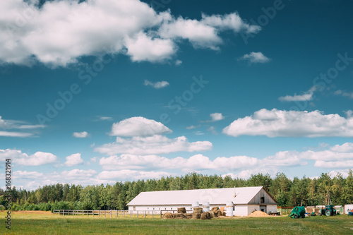 Countryside Rural Landscape With Farm Paddock For Horse, Shed Or Barn Or Stable With Haystacks In Lat Summer Season.