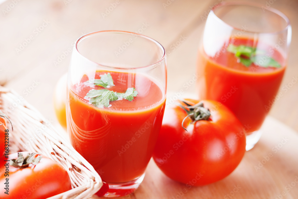 Tomatoes and glasses of fresh tomato juice Tomatoes and glasses of fresh tomato juice