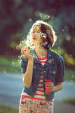 Portrait of teenager blowing soap bubbles 