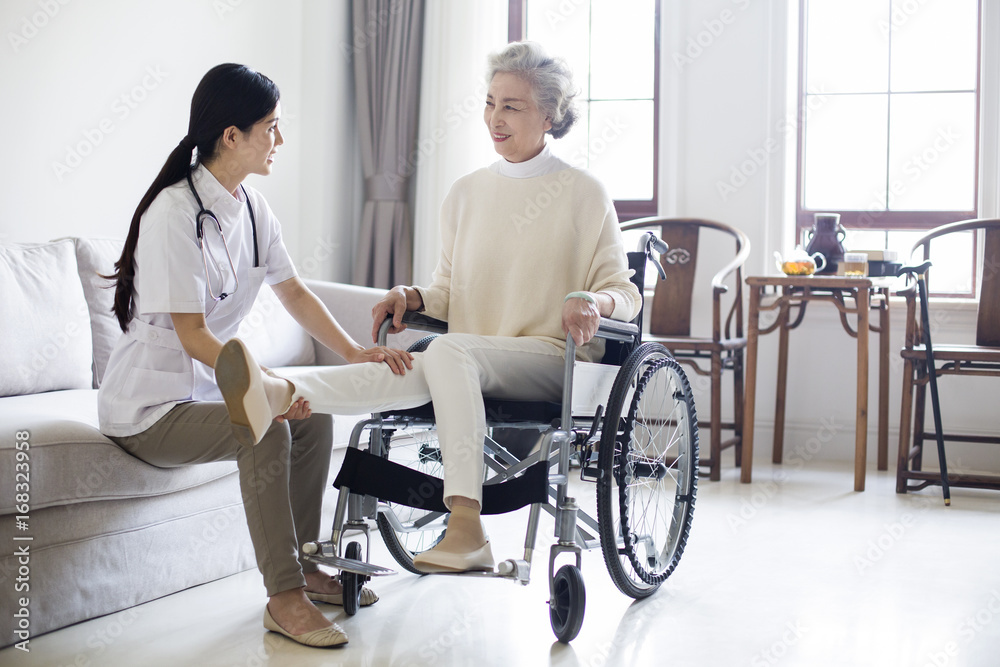 Nursing assistant taking care of senior woman in wheel chair Nursing assistant taking care of senior woman in wheel chair