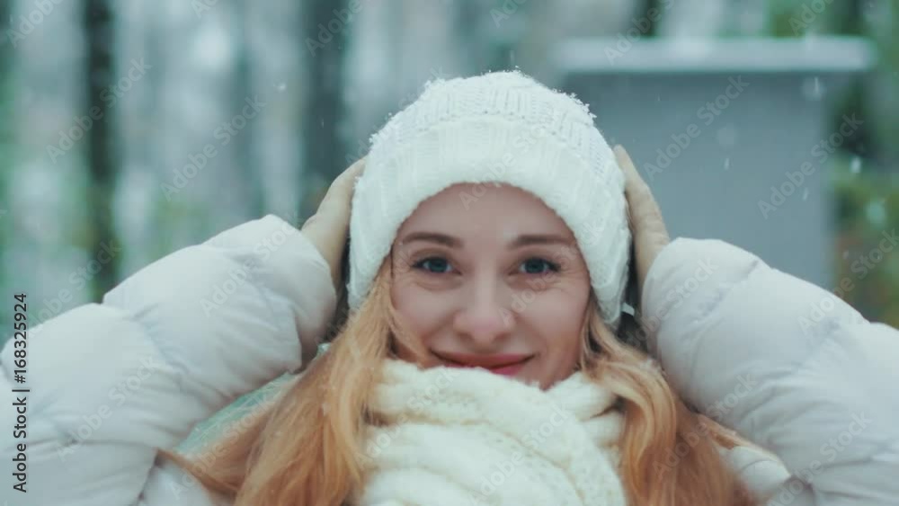 Beautiful young woman smiling and looking at camera on a winter day.