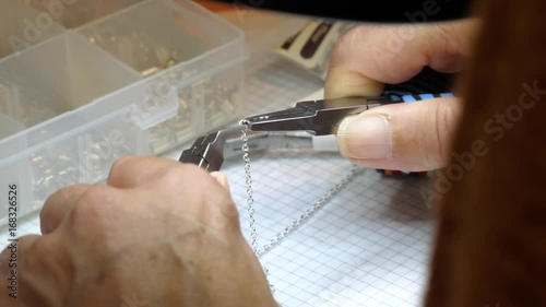 jewelry handmade by experienced woman with tools in her studio