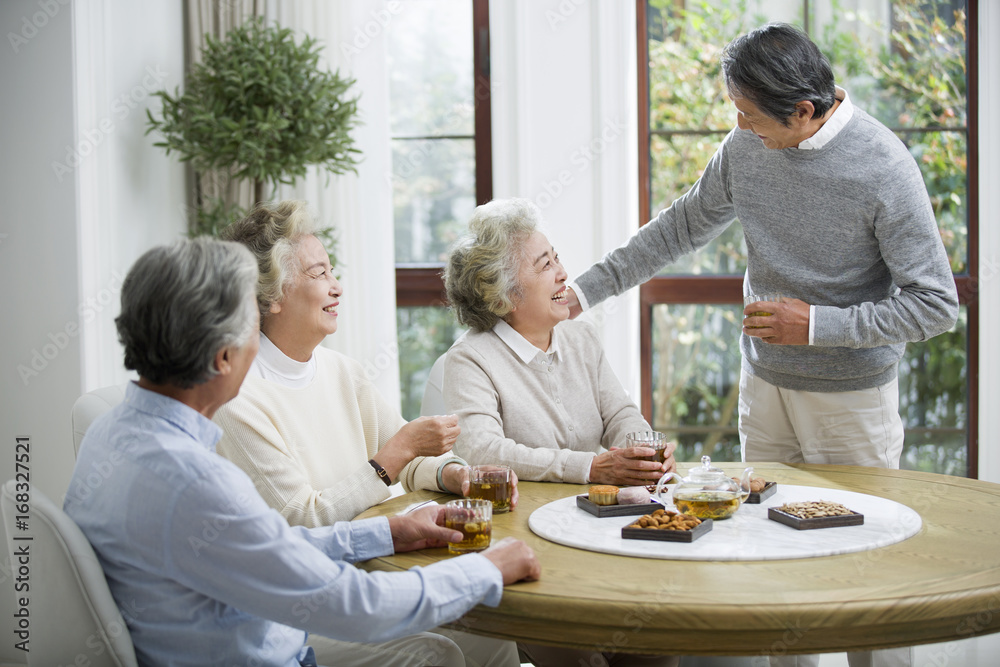 Happy senior friends talking and drinking tea Happy senior friends talking and drinking tea
