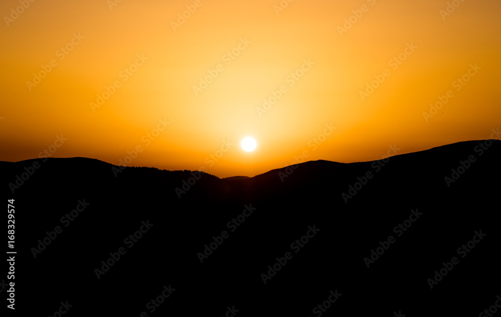 Sunset against the background of mountains