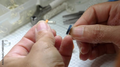 jewelry handmade by experienced woman with tools in her studio