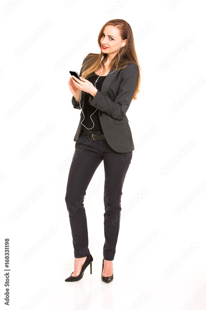 Dark blonde beautiful woman wearing smart casual outfit and holding smartphone and listening music on white background Dark blonde beautiful woman wearing smart casual outfit and holding smartphone and listening music on white background