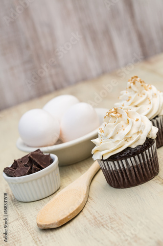 Chocolate Cupcakes Eggs Wood Spoon and Pieces photo