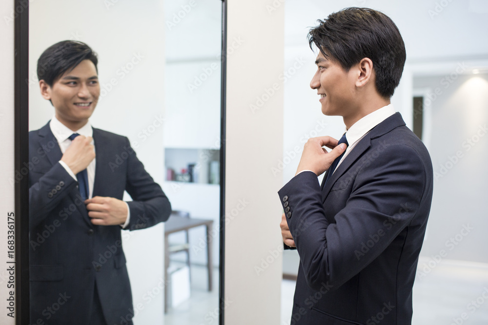 Young businessman getting dressed in the morning Young businessman getting dressed in the morning