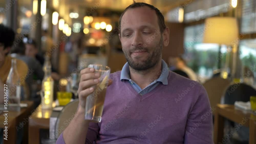 Young, happy man drinking cocktail sitting in cafe
Young, happy man drinking cocktail sitting in cafe