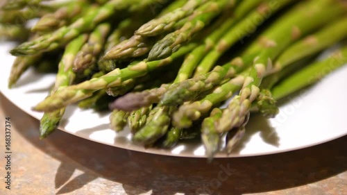 Asparagus. Raw asparagus. Fresh Asparagus. Green Asparagus on plate. Close up on the tips.