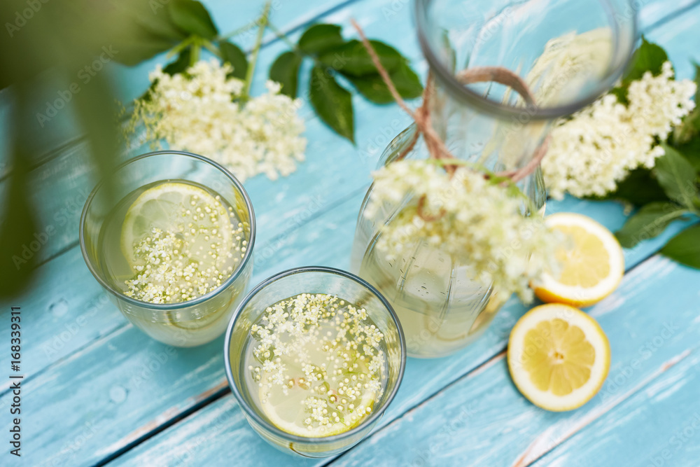 Two glasses of elderflower lemonade and carafe, top view Two glasses of elderflower lemonade and carafe, top view