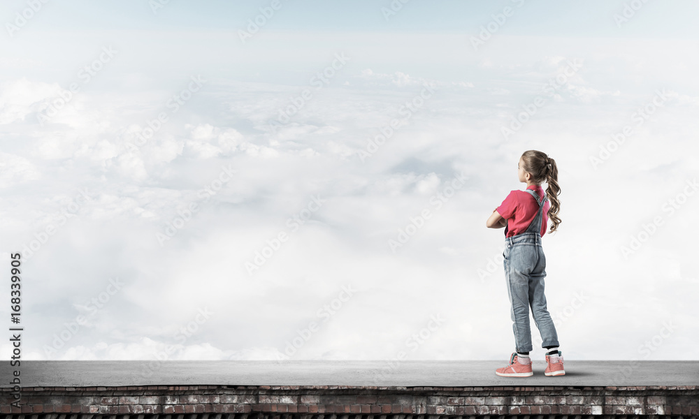 Concept of careless happy childhood with girl looking far away Concept of careless happy childhood with girl looking far away