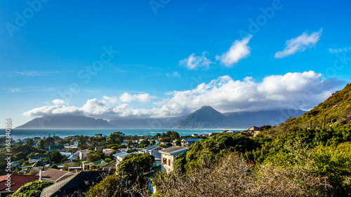 The village of Het Kommetjie with its famous kite-surfing beach in the Cape Peninsula of South Africa with Table Mountain in the background
