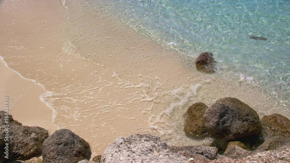 Clear Tropical Ocean Water Softly Breaking on Pink Sand Against Natural Rocks on the Bahamian Island National Capital of Nassau Bahamas on a Sunny Day Clear Tropical Ocean Water Softly Breaking on Pink Sand Against Natural Rocks on the Bahamian Island National Capital of Nassau Bahamas on a Sunny Day