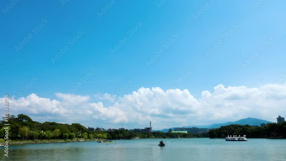Time lapse of cumulus crowds growing over lake in public park
Time lapse of cumulus crowds growing over lake in public park