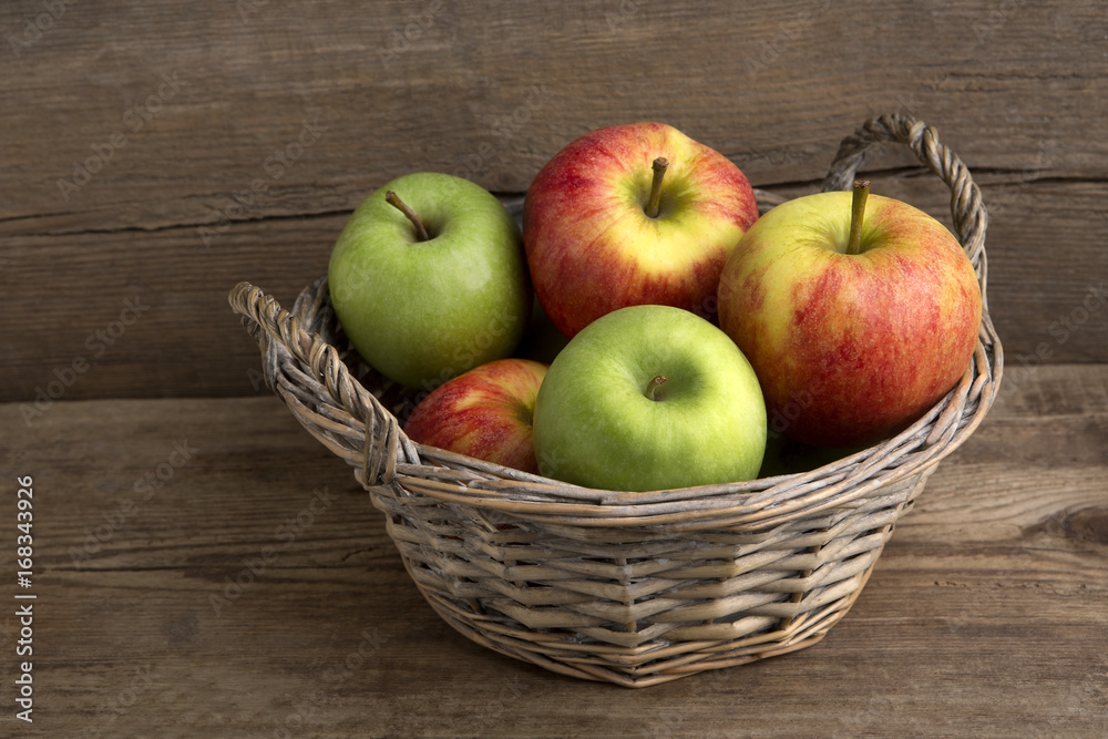 Basket of fresh apples on wooden background Basket of fresh apples on wooden background