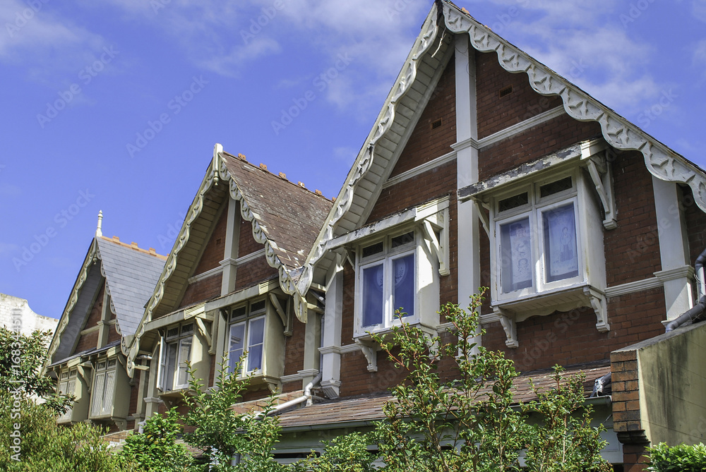 Top floor and classical roof gables in Sydney neighbourhood, inhabited by Asians