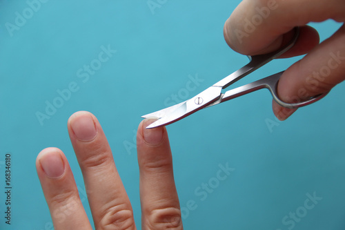 Cutting the nails with scissors