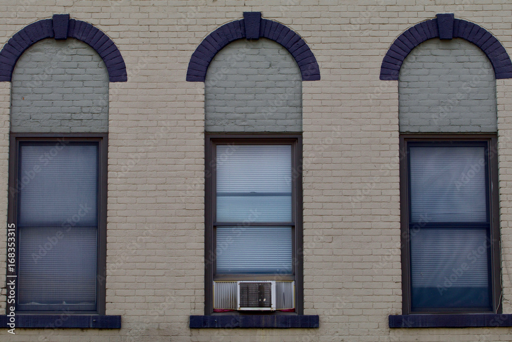 Three windows from a nineteenth century brick building