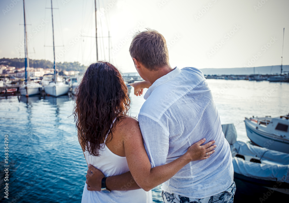 Back view, couple hug on boat marine background. Travel and adventure concept idea