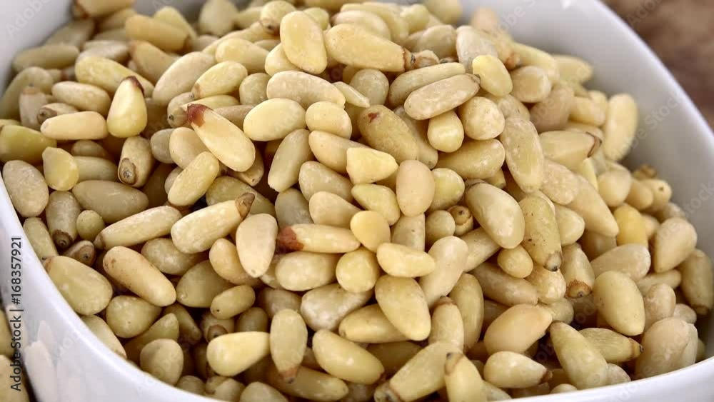 Pine Nuts on a rotating wooden plate (seamless loopable; 4K) Pine Nuts on a rotating wooden plate (seamless loopable; 4K)