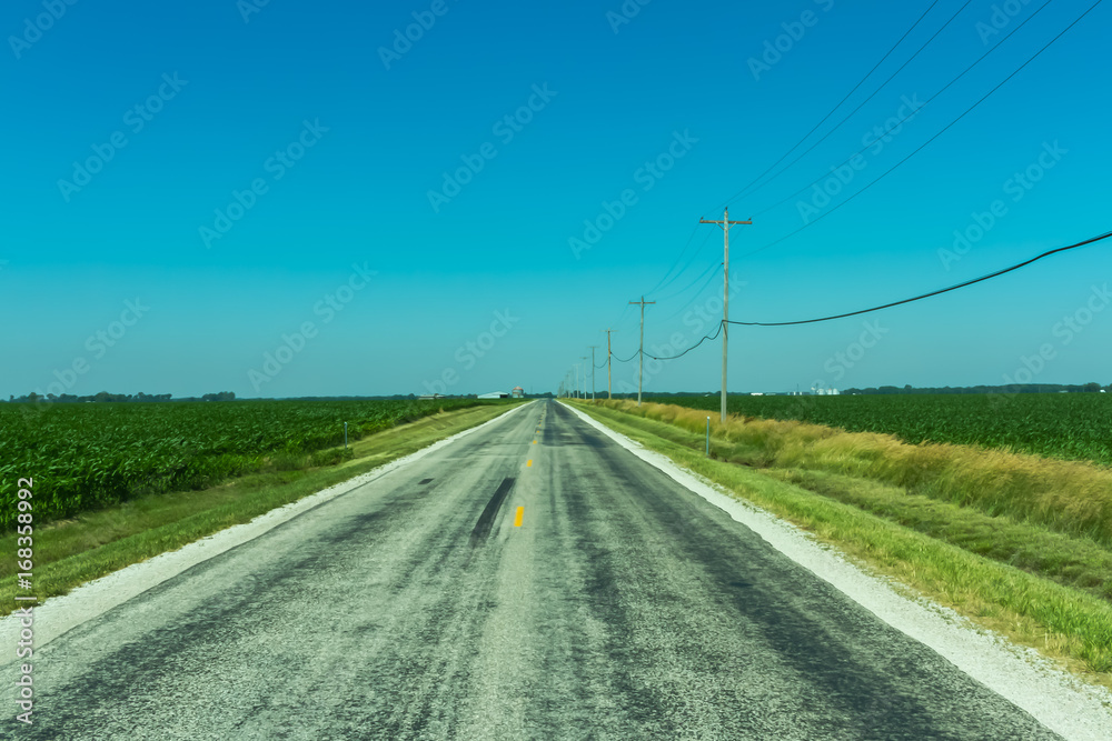 Fototapeta premium Route 66 through Illinois farmland Royalty free stock photo